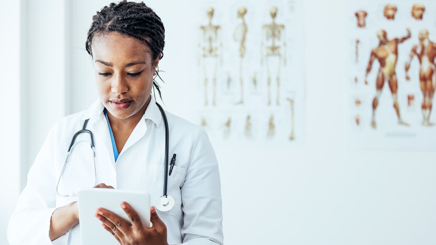 A healthcare professional using a digital tablet